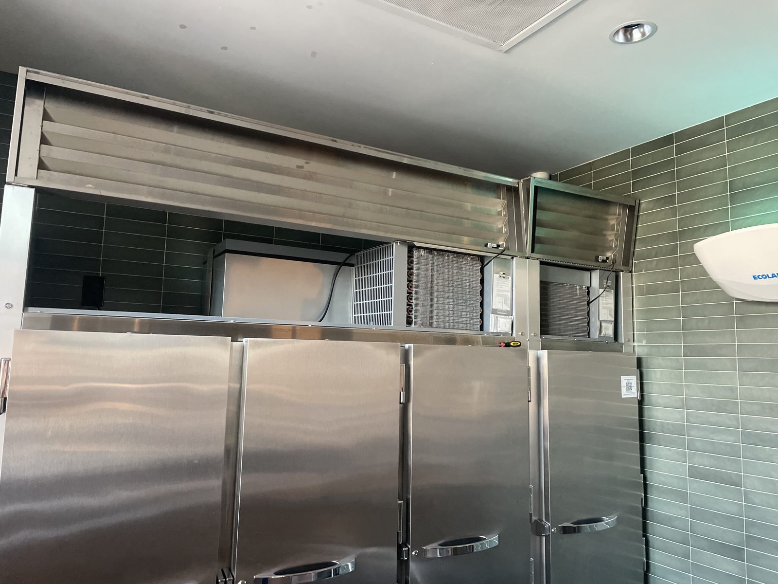 Commercial stainless steel reach-in refrigerators and freezers with overhead condenser units